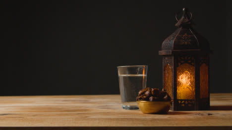 Tracking-Shot-of-a-Lantern-Water-and-Dates-On-a-Table-for-Ramadan